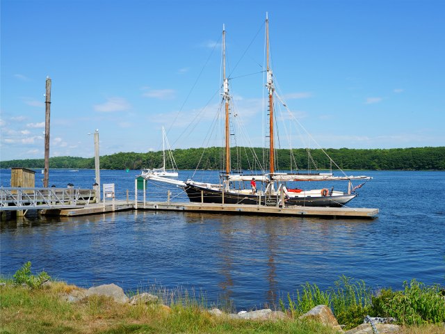 A picture of a large sailboat docked in the water