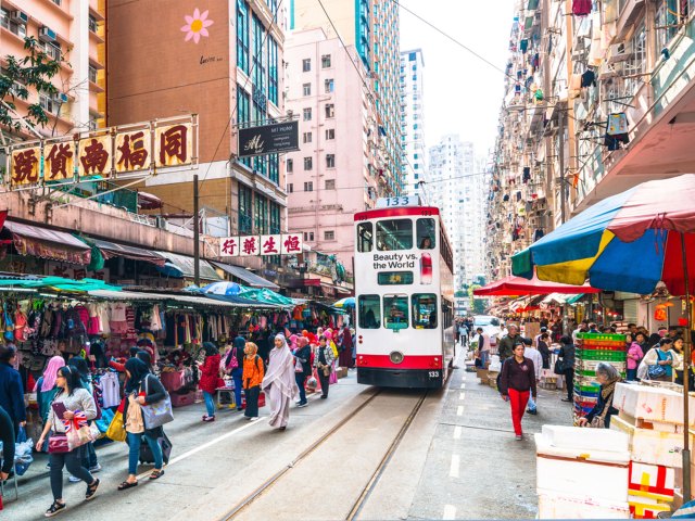 Double-decker bus and street crowded with pedestrians in Hong Kong