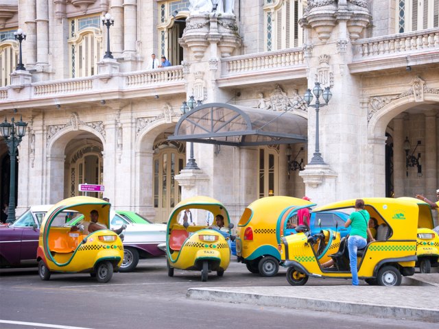 Yellow coconut-shaped taxis on streets of Havana, Cuba