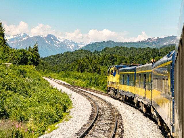 Train traveling through Alaska mountains