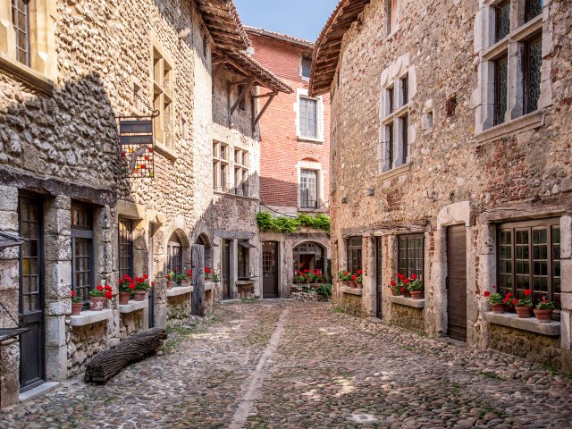 A picture of grey cobble streets surrounded by grey stone buildings