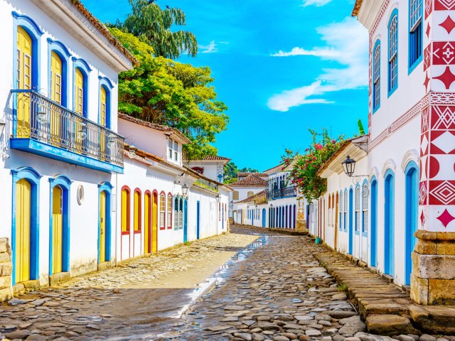Blue-and-white painted buildings line cobblestone street in Rio de Janeiro, Brazil