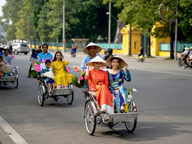 People riding cyclos in Hanoi, Vietnam
