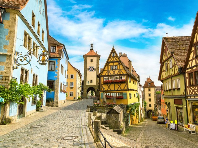 A picture of a cobblestone street lined with colorful, medieval buildings