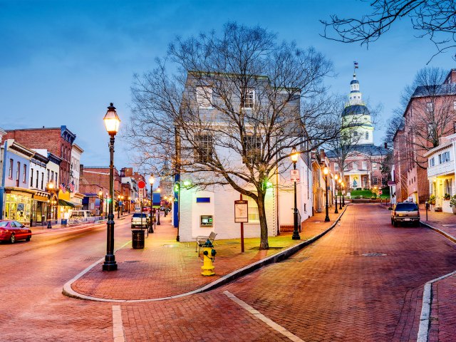 Downtown Annapolis, Maryland, lit in the evening, with state house in background
