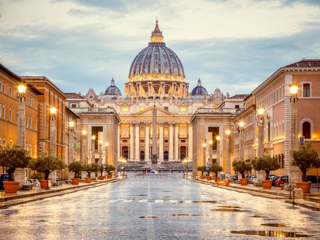 View down empty street of Sistine Chapel on a rainy evening