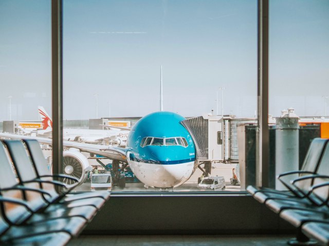 View from airport seating area of airplane parked at gate