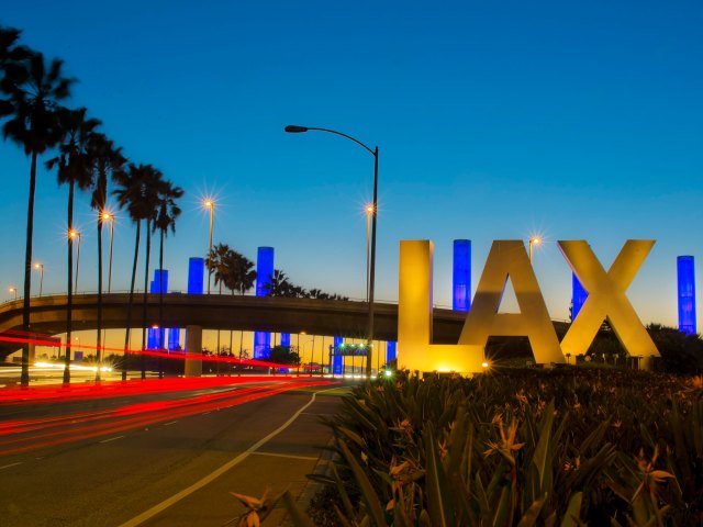 Signs for LAX Airport light at night