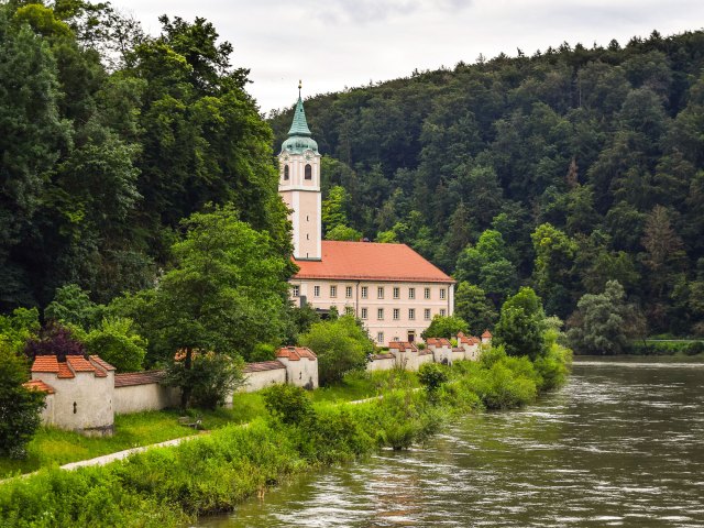 View of Weltenburg Abbey in Germany next to river