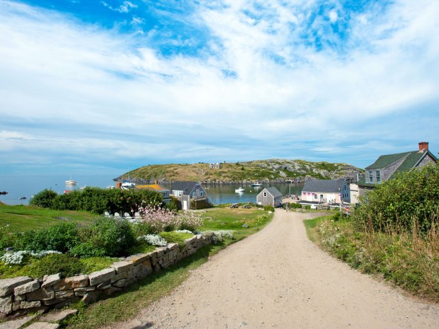 A picture of quaint homes sitting on a bay