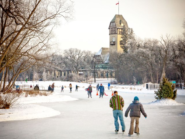 A picture of people ice skating on a frozen river