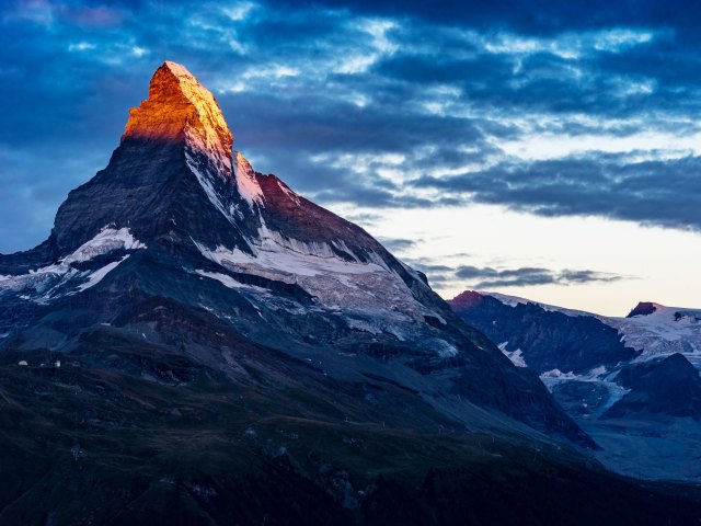 Sun partially shining over Matterhorn mountain in Switzerland