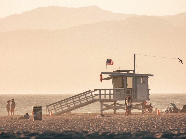 Lifeguard tower and people on beach in Santa Monica, California