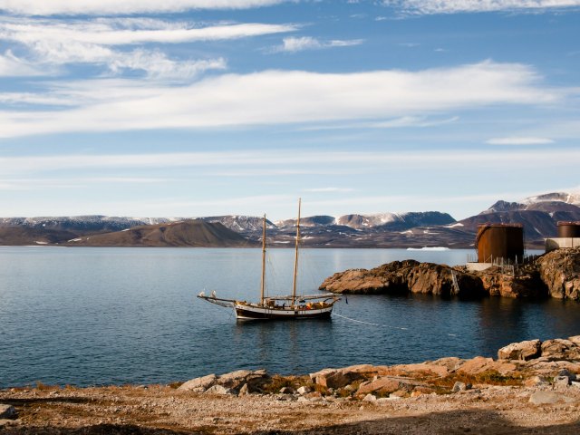 Tall ship moored off the rocky coast of Ittoqqortoormiit, Greenland