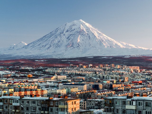 Aerial view of Petropavlovsk-Kamchatsky, Russia with snow-covered volcano in background