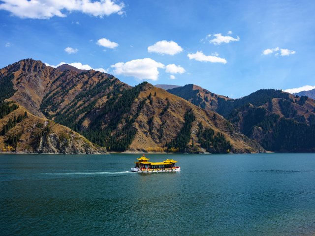 Yellow boat in lake surrounded by mountains in Ürümqi, China