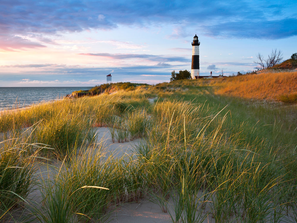 Lighthouse overlooking coastal dunes and Lake Michigan shoreline