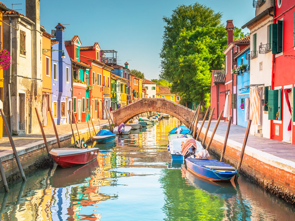 Gondolas and colorful buildings lining canal in Venice, Italy