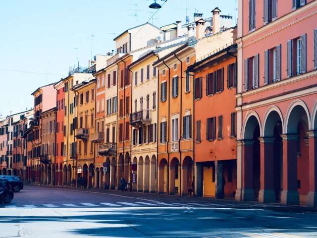 Buildings painted in pink, orange, and yellow in Bologna, Italy