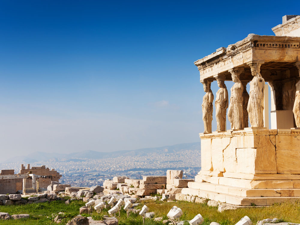 A picture of the columns of the Parthenon overlooking the city of Athens