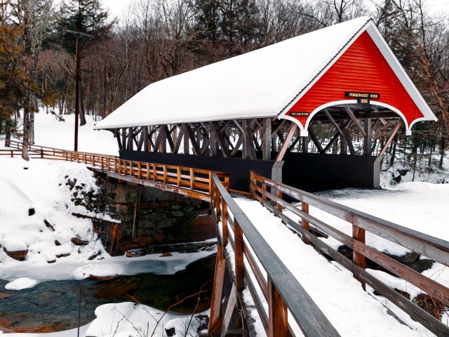 Covered bridge in New Hampshire amid snowy landscape