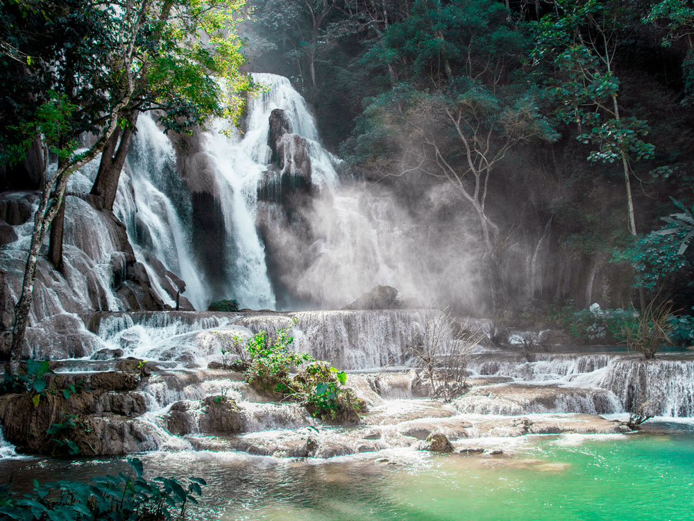 Roaring multi-tiered cascades of Kuang Si Falls in Laos