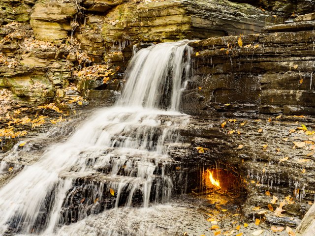 Flame burning beneath waterfall in western New York