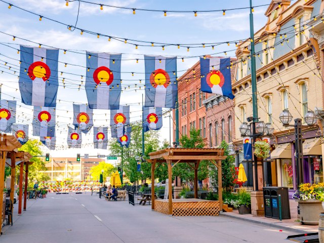 Colorado flags flying over pedestrian street in Denver, Colorado