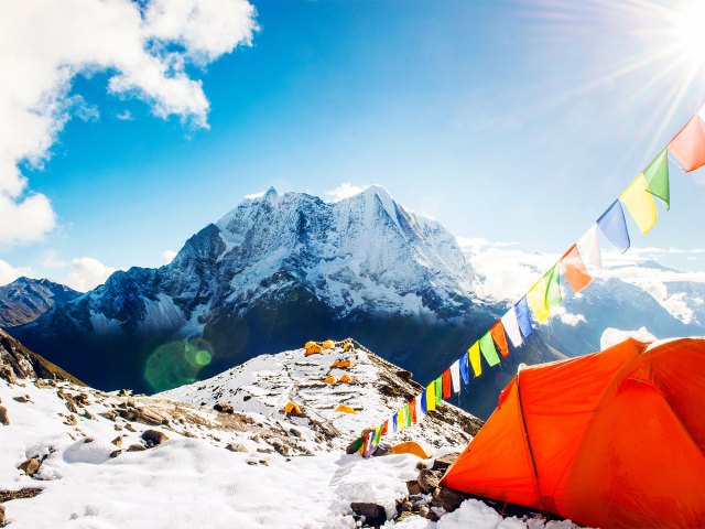 Colorful flags flying over tents on Mount Everest