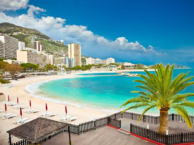 Overview of sandy crescent-shaped beach in Monaco