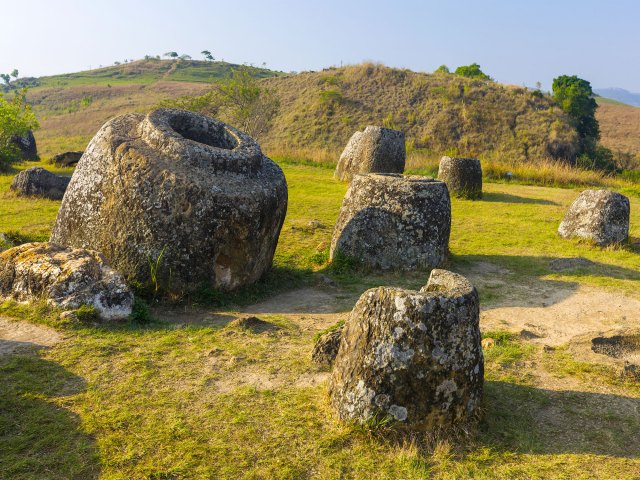 Giant jar-shaped stones on field in Laos