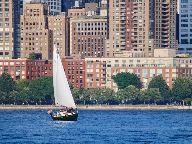 Sailboat with city buildings in background