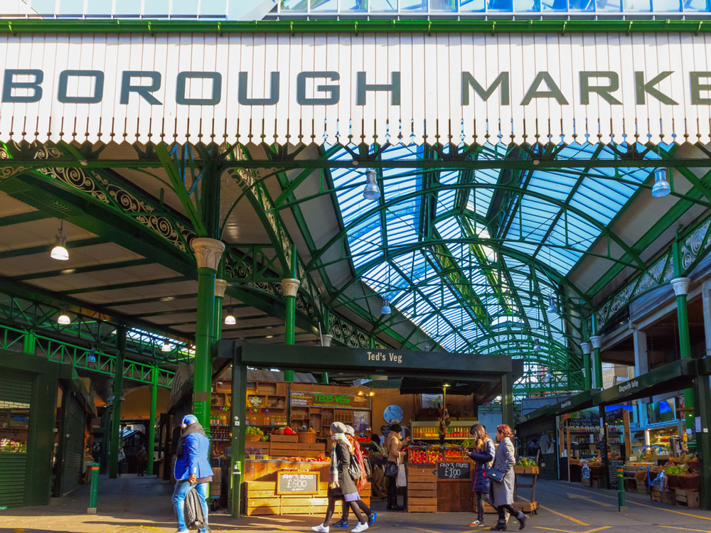 People browsing food stalls at Borough Market in London, Eengland