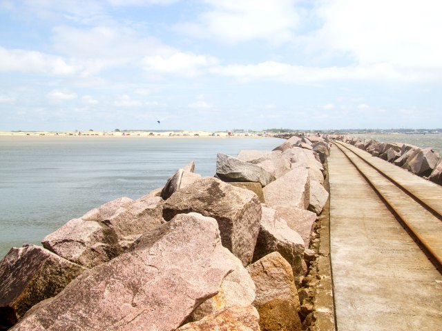 Boulders lining beachfront pathway at Brazil's Praia do Cassino