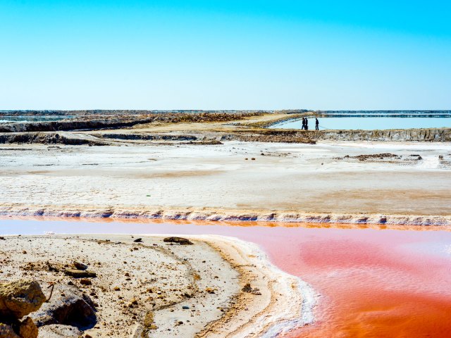 Salty landscape and pinkish red water colored by minerals at Chott el Djerid in Tunisia