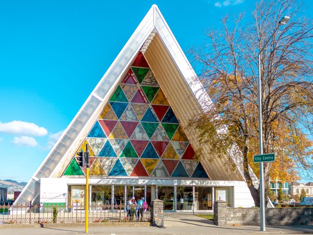 Triangular exterior of the Christ Church Cathedral with colorful mosaic stained glass