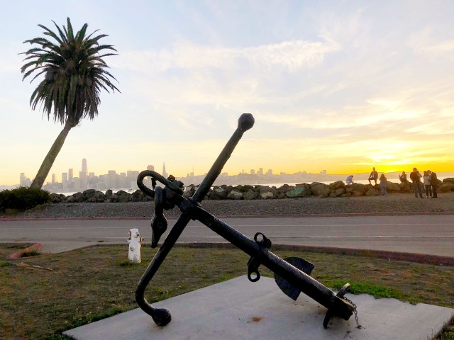 Statue of anchor on Treasure Island with San Francisco skyline visible in distance