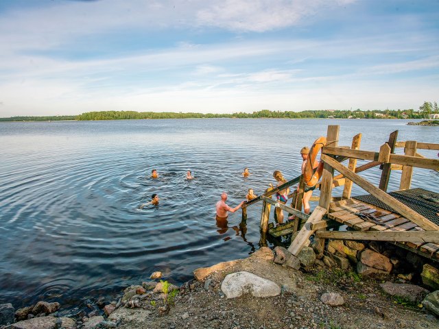 Finnish people taking dip in lake after sauna session