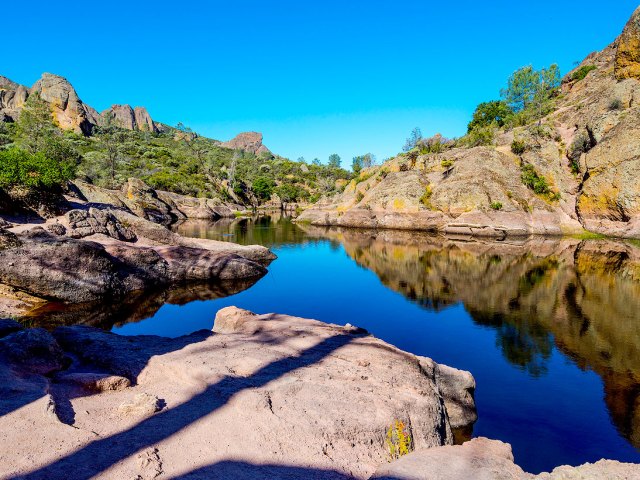 Lake surrounded by rocky landscape of Pinnacles National Park in California