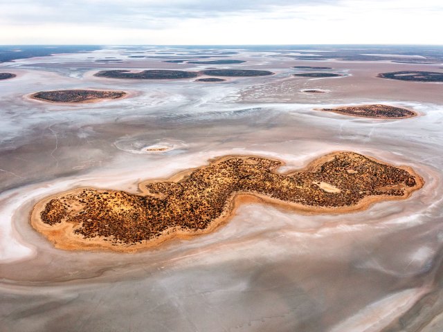Aerial view of small island in Australia's Lake Amadeus salt pan