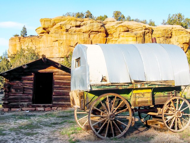 Covered wagon and log cabin in Dinosaur, Colorado