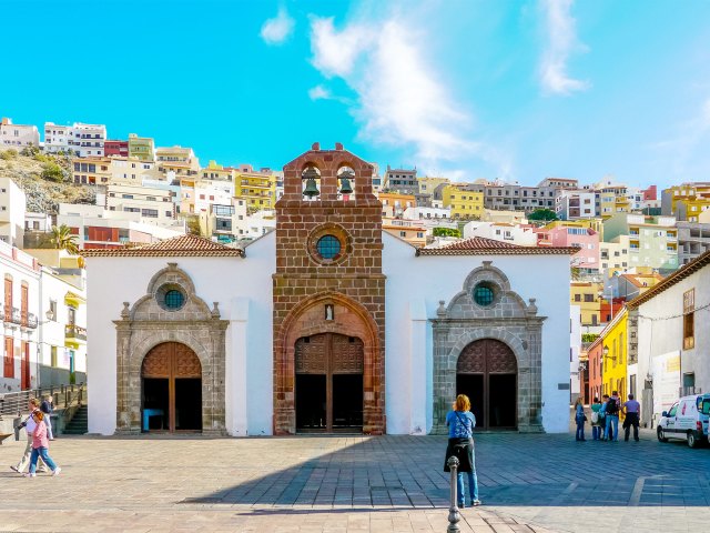 Church and town square with hilltop homes in background on La Gomera in the Canary Islands