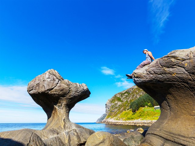 Person admiring Kannesteinen Rock off the coast of Norway