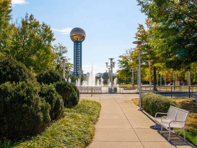 Bench and fountain in Knoxville park with Sunsphere in background