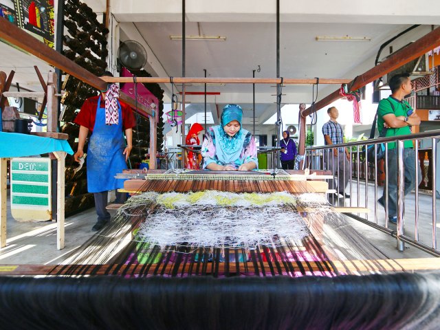 Malay woman using traditional weaving method