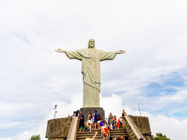 People admiring Christ the Redeemer statue in Rio de Janeiro, Brazil