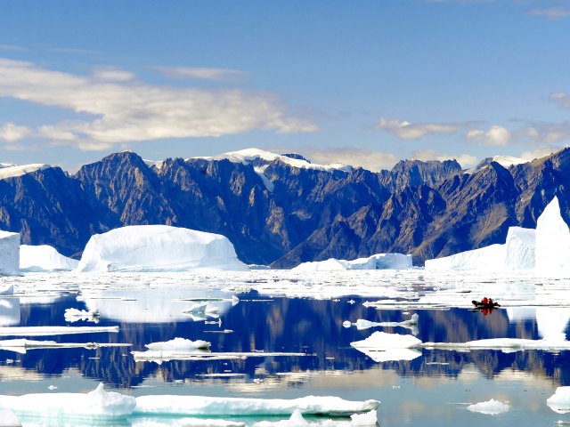 Mountains, glaciers, and icebergs floating on lake in Northeast Greenland National Park