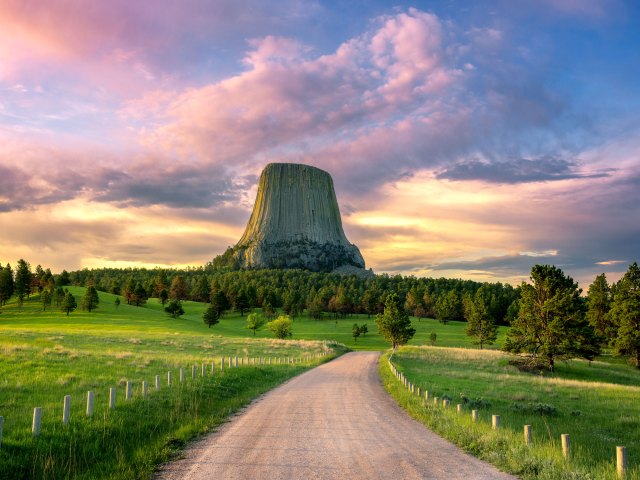 Road leading to Devils Tower National Monument in Wyoming at sunset