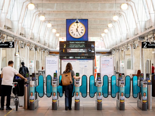 London Underground riders entering turnstiles in station