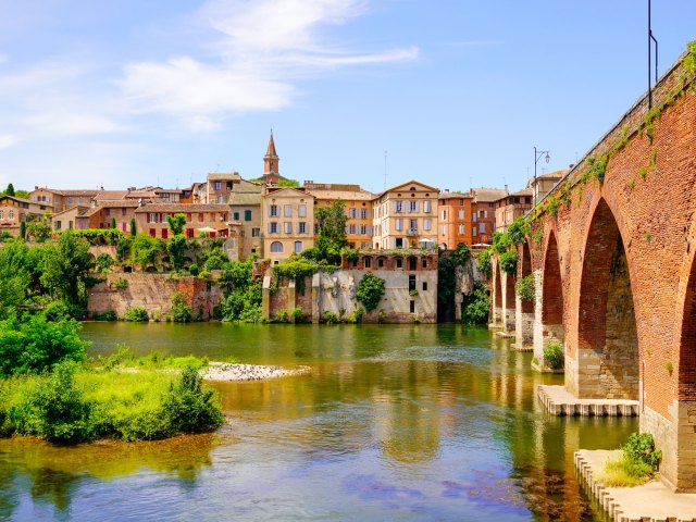 View of bridge and buildings across river in Episcopal City of Albi, France